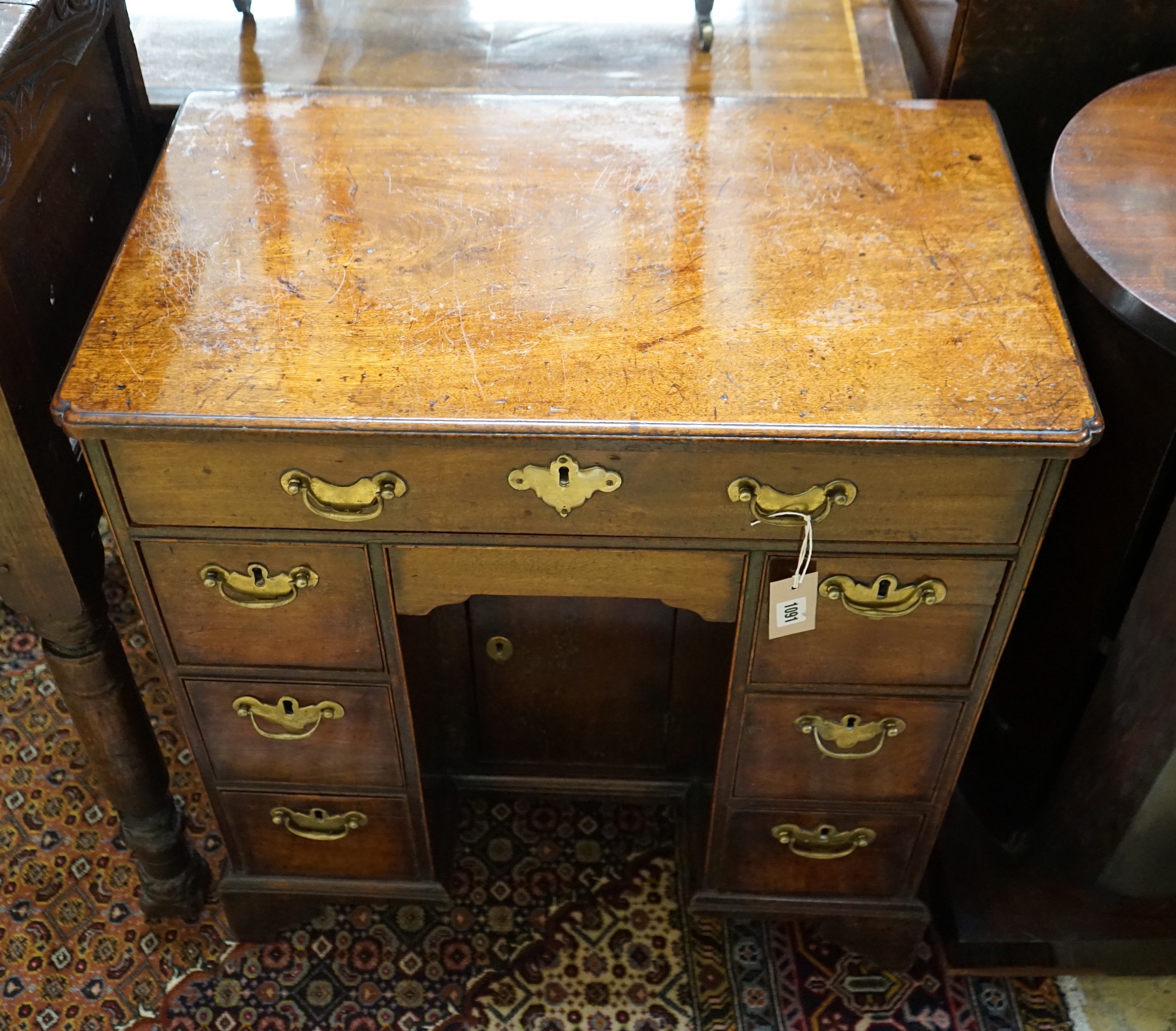 A small 18th century and later mahogany kneehole desk, width 68cm, depth 41cm, height 74cm